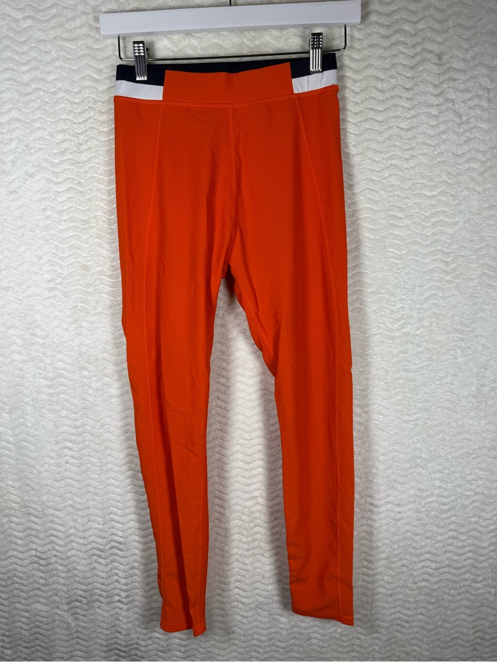 Wilo The Label orange leggings, distinguished by their navy trim and white